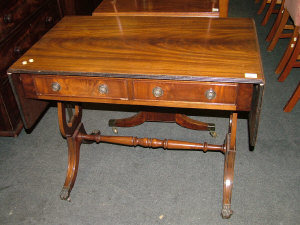 Appraisal: A Reproduction mahogany sofa table the rounded top above two