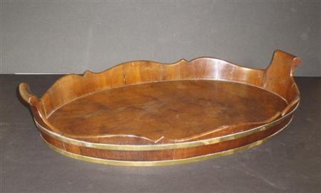 Appraisal: A late George III mahogany and brass bound oval tray