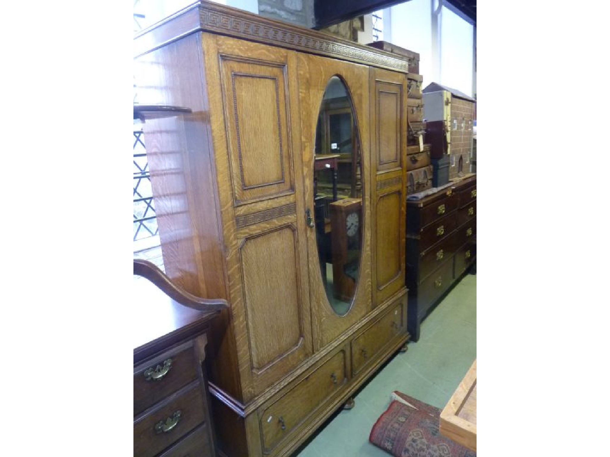 Appraisal: An Edwardian oak wardrobe enclosed by a single mirror panelled