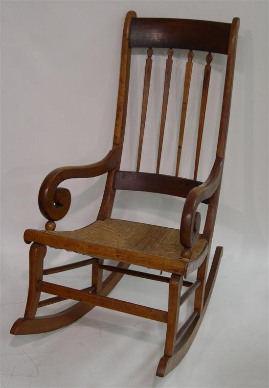 Appraisal: Scrolled arm rush seat rocking chair shaped spindle back loss