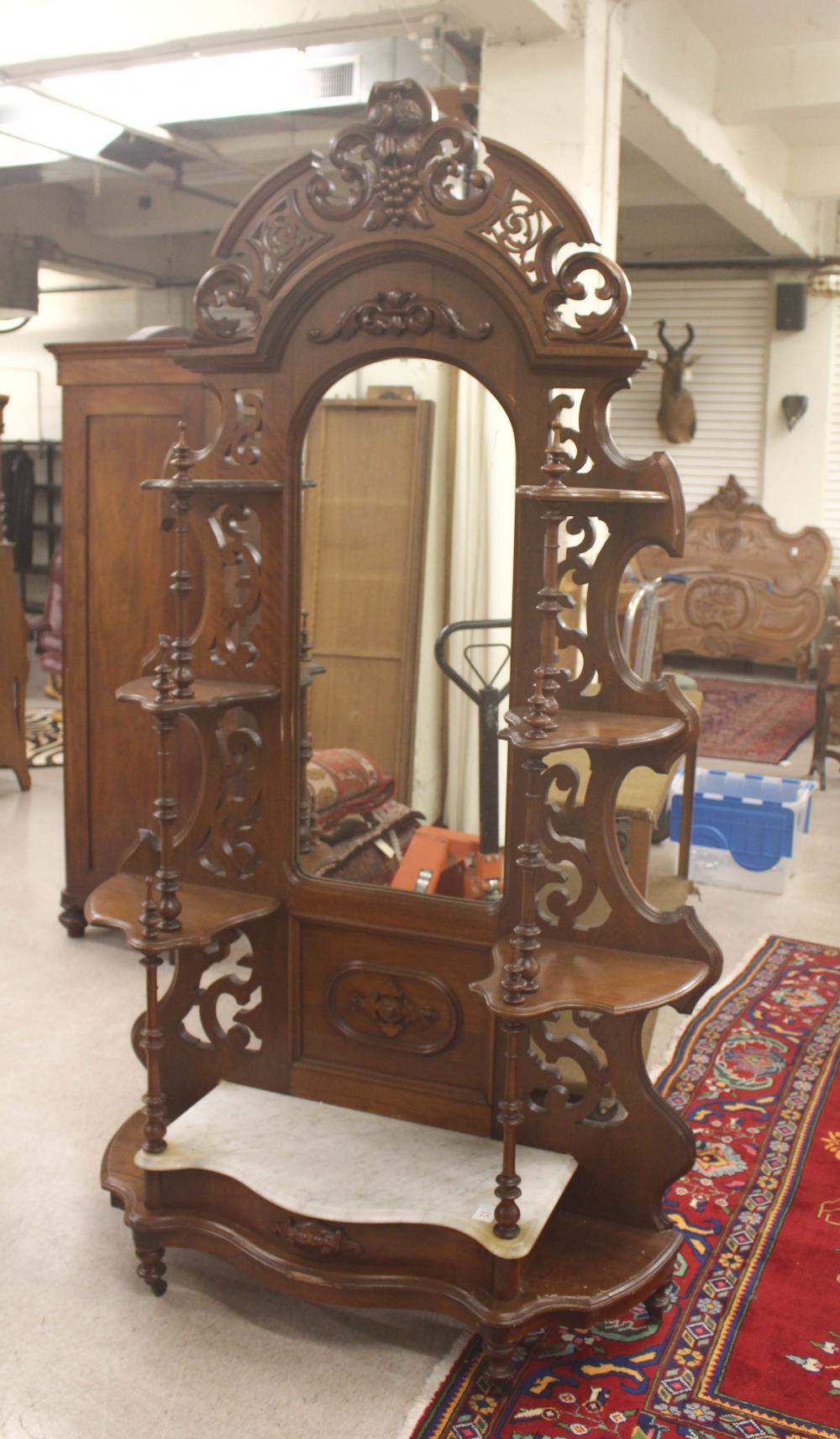 Appraisal: VICTORIAN WALNUT ETAGERE American c open shelves around a centralized