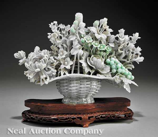 Appraisal: A Chinese Carved Jade Jadeite Flower Laden Basket the mottled