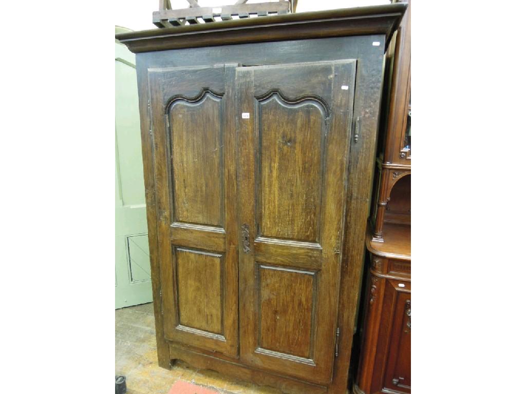 Appraisal: An antique oak armoire enclosed by a pair of twin