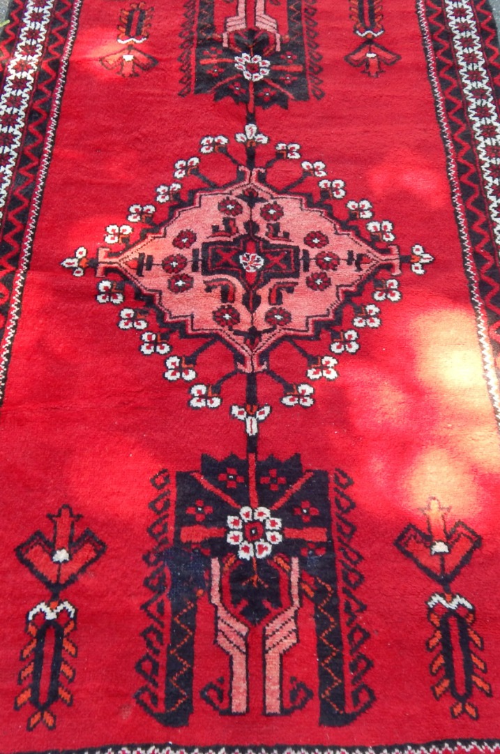 Appraisal: A Gonbad Iranian rug upon red ground with central lozenges