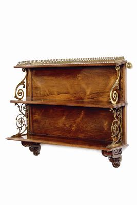 Appraisal: A late Regency set of rosewood graduated hanging shelves with