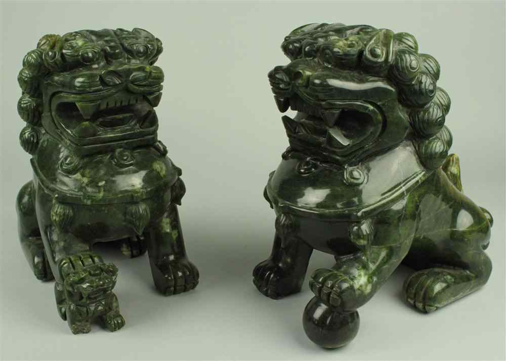 Appraisal: PAIR OF DARK HARDSTONE BUDDHISTIC LIONS the male and female