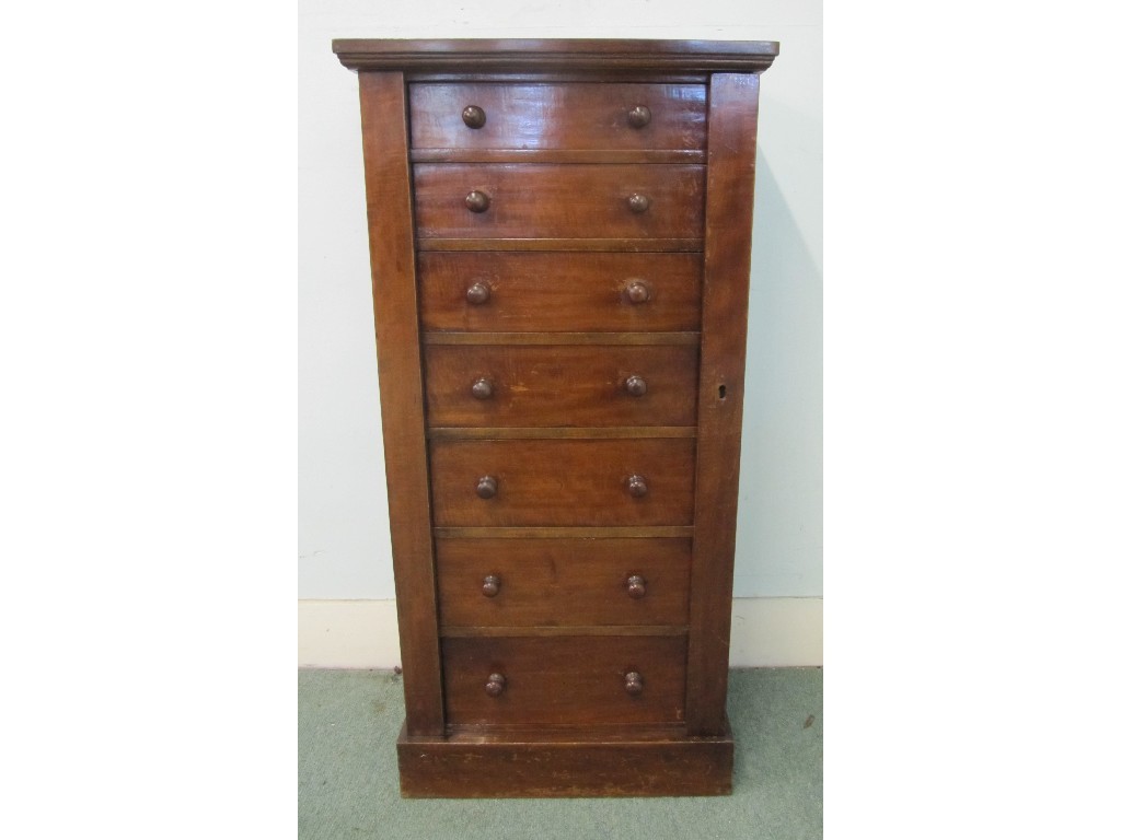 Appraisal: A Victorian mahogany Wellington chest bearing seven graduated drawers with