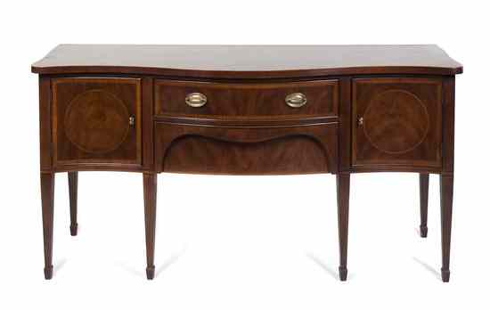 Appraisal: A Georgian Style Mahogany Sideboard having a serpentine top over