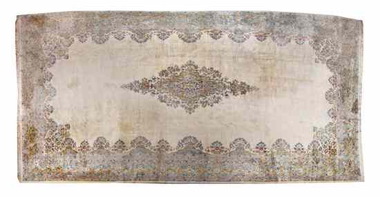 Appraisal: A Kirman Wool Rug having a diamond center medallion on