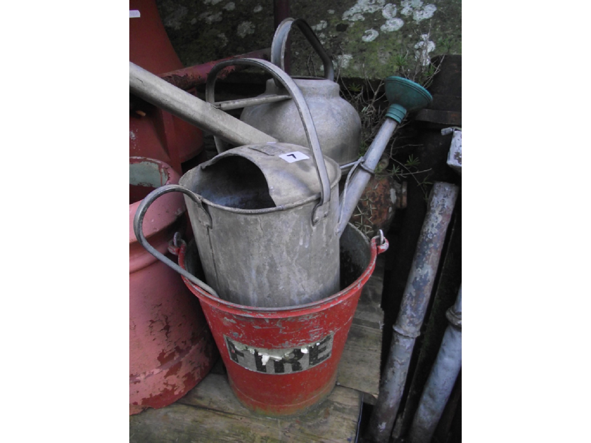 Appraisal: Two vintage galvanised watering cans of varying design a galvanised