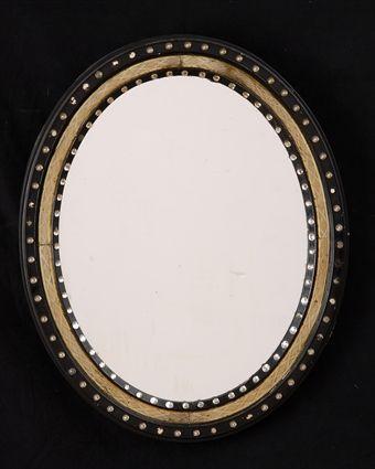 Appraisal: IRISH REGENCY-STYLE GLASS BEAD PARCEL-GILT AND EBONIZED MIRROR The oval