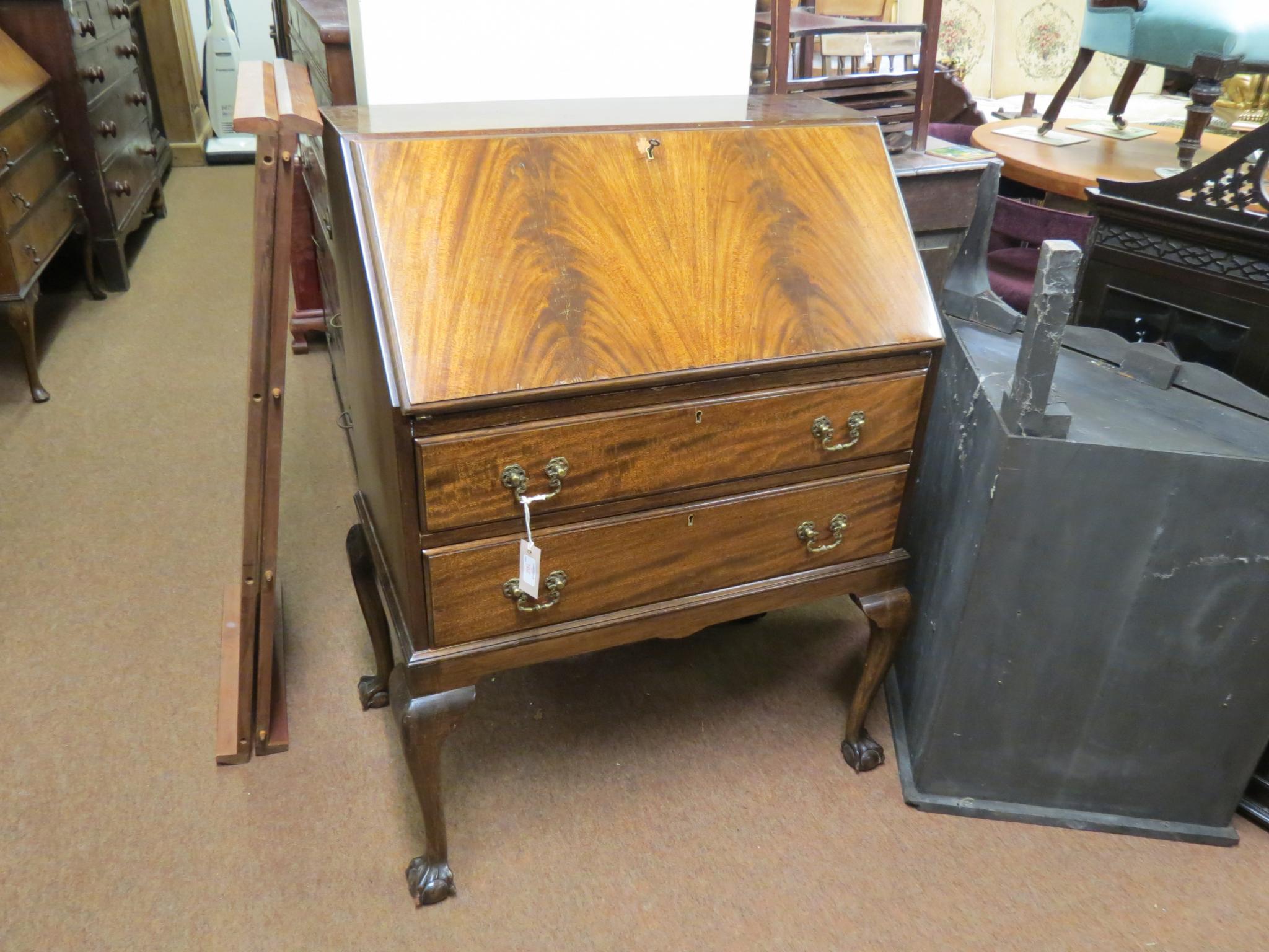 Appraisal: An early th century mahogany bureau flame-veneered fall-front enclosing pigeon