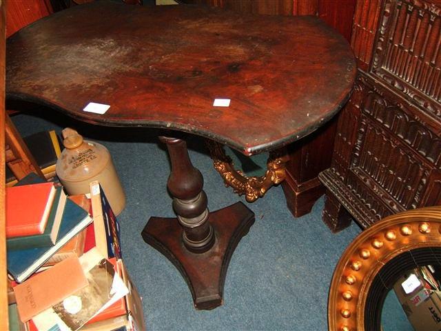 Appraisal: A Victorian mahogany occasional table with shaped top turned column