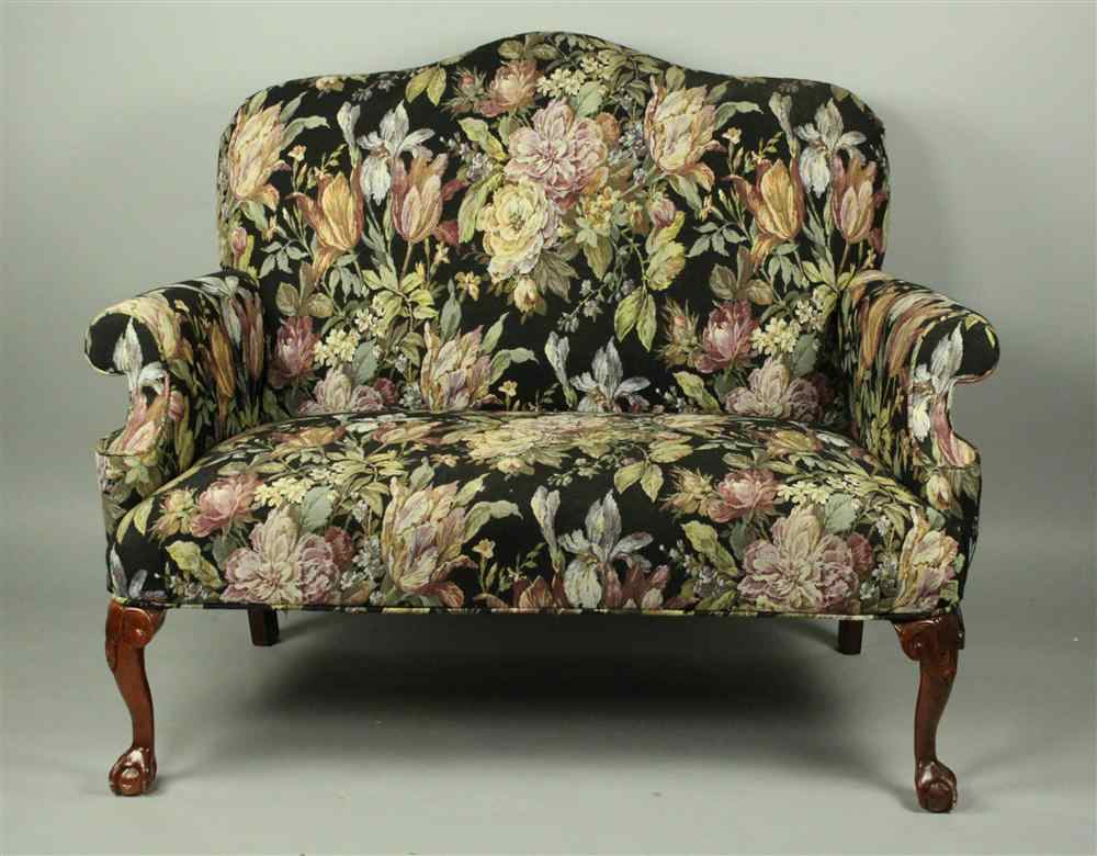 Appraisal: CHIPPENDALE STYLE UPHOLSTERED SETTEE having a scrolling crest with rolled