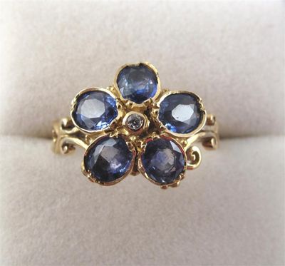 Appraisal: A sapphire and diamond flower head ring set in gold