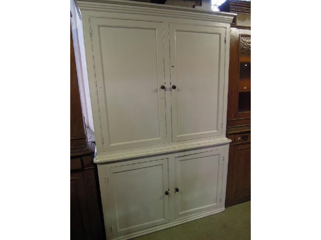 Appraisal: A th century two sectional pine housekeeper's cupboard enclosed by