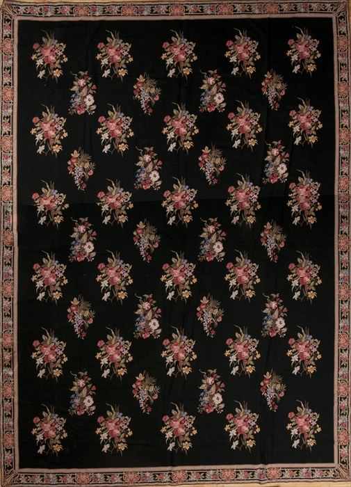 Appraisal: NEEDLEWORK CARPET The black field worked with floral clusters within