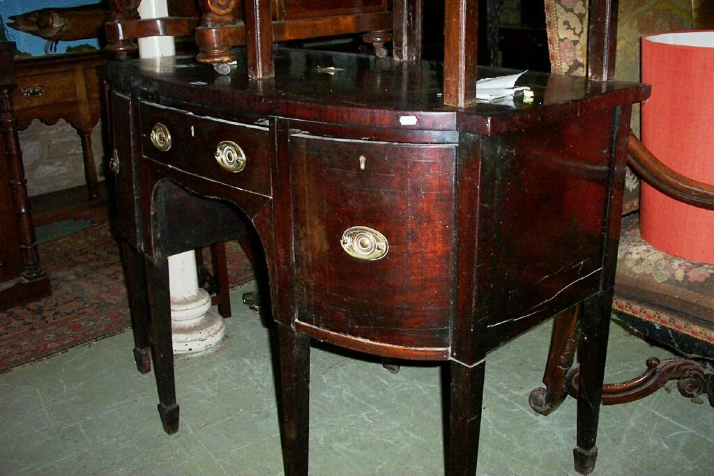 Appraisal: A small Regency mahogany bow fronted sideboard the central drawer