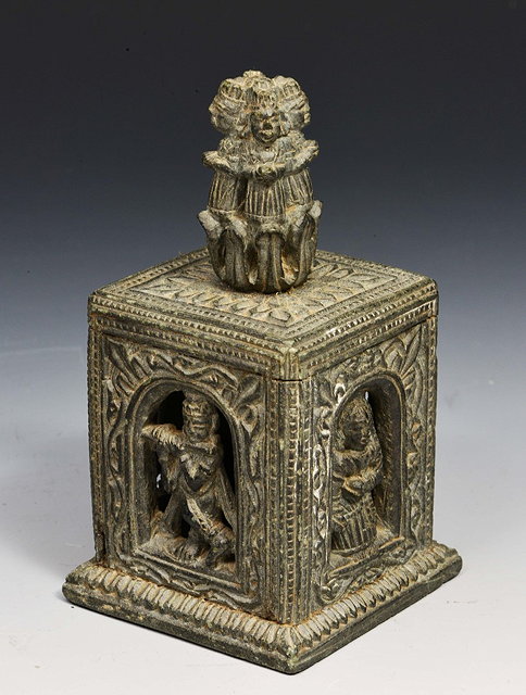 Appraisal: AN INDIAN CARVED BLACK STONE SHRINE decorated male and female