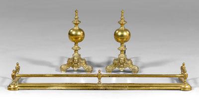 Appraisal: Pair andirons fender andirons with bold baluster shafts above mask