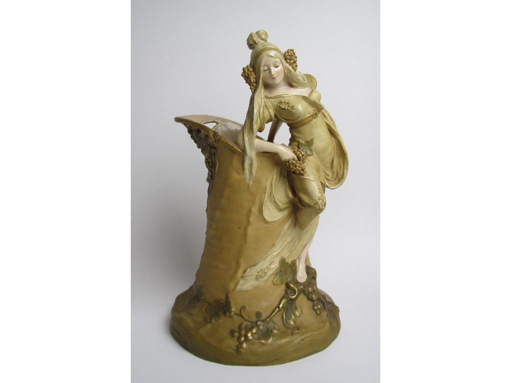 Appraisal: A Vienna porcelain vase modelled as a maiden leaning on