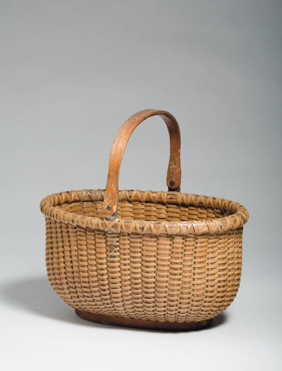 Appraisal: NANTUCKET OVAL LIGHTSHIP BASKET WITH SWING HANDLE CIRCA The mahogany