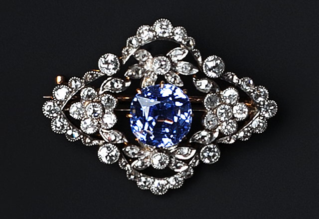 Appraisal: A SAPPHIRE AND DIAMOND PANEL BROOCH the cushion-shaped mixed-cut sapphire