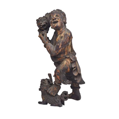 Appraisal: Lacquered Wood Figure of a Boy and Fu-Lions th Century