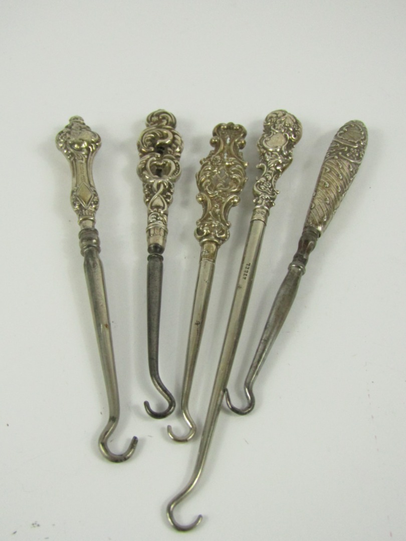 Appraisal: Five late Victorian Edwardian steel button hooks three with hallmarked