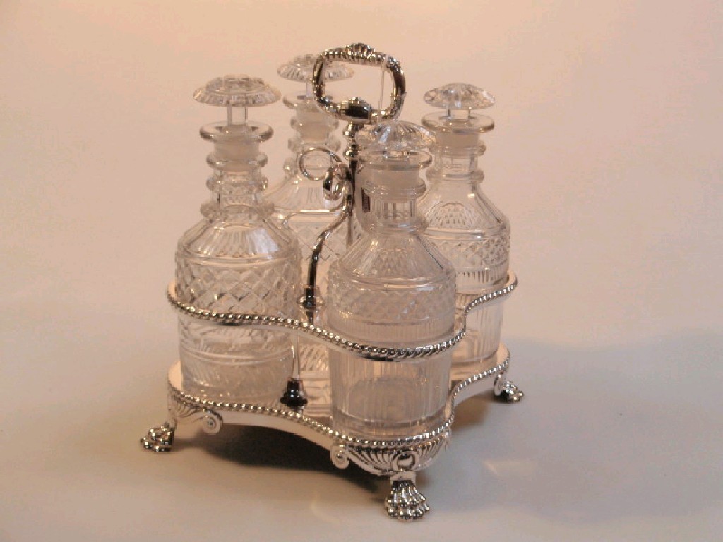 Appraisal: A Victorian silver plated four bottle decanter stand with cut