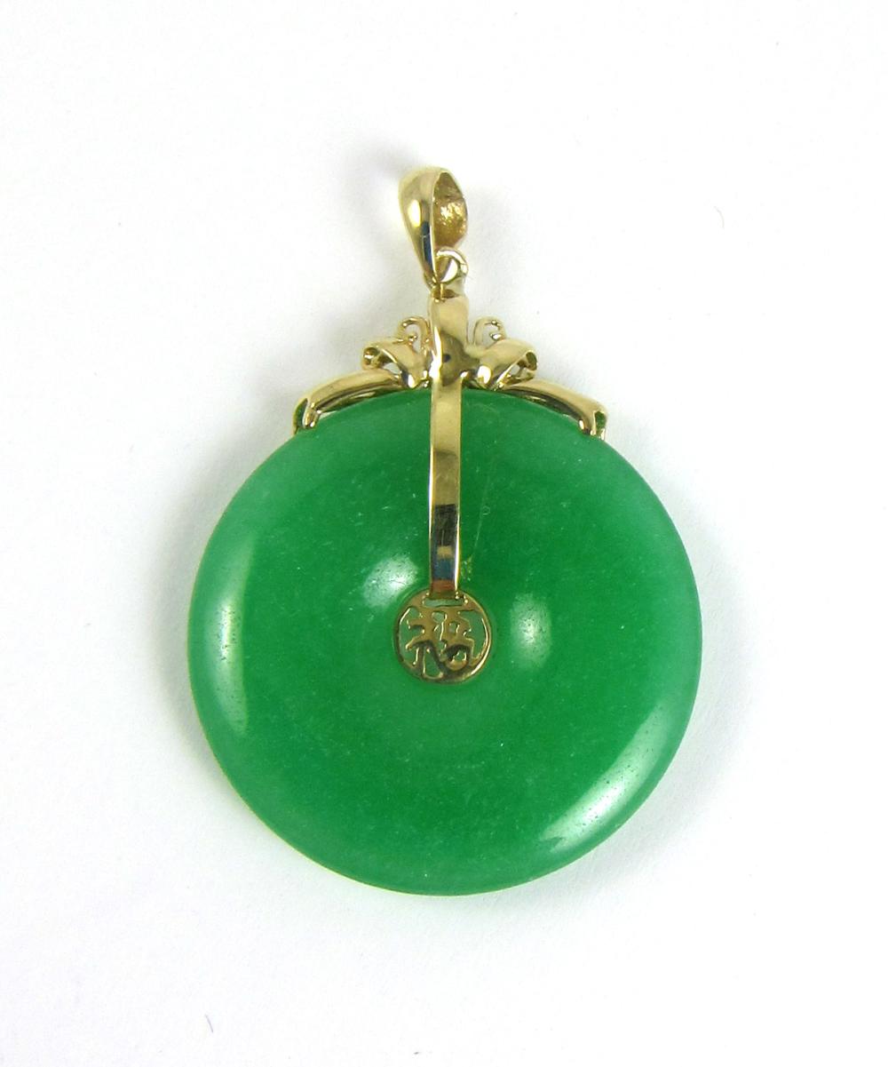 Appraisal: GREEN JADE AND FOURTEEN KARAT GOLD PENDANT with a mm