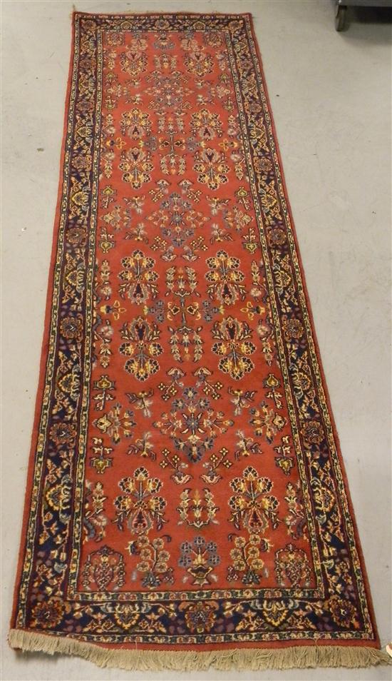 Appraisal: Persian runner red field navy accents handknotted ' '' l