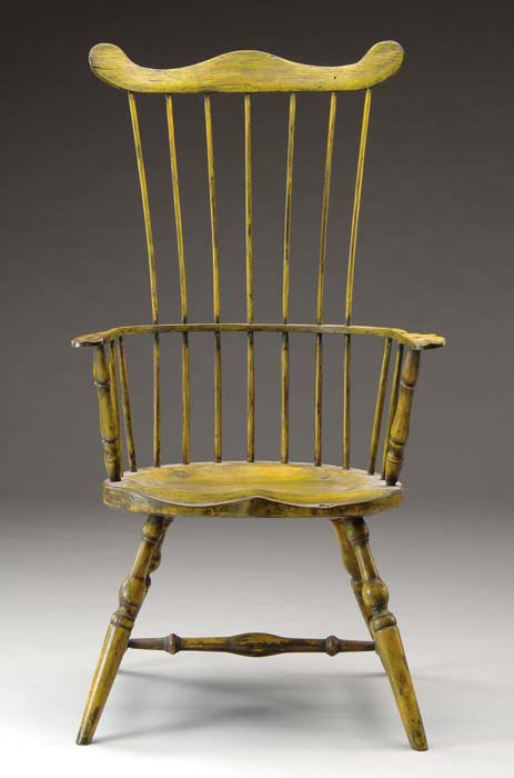 Appraisal: COMB-BACK WINDSOR ARMCHAIR IN YELLOW PAINT Carved saddle seat seven