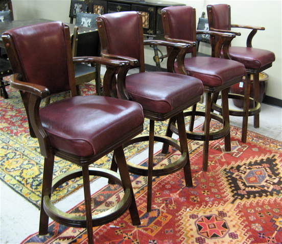 Appraisal: SET OF FOUR SWIVEL ARMCHAIR BARSTOOLS with burgundy leather upholster