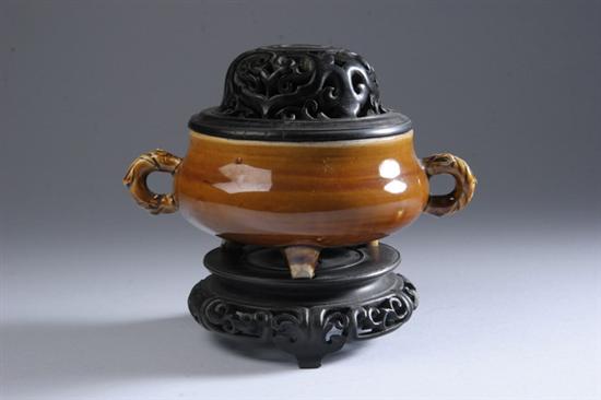 Appraisal: CHINESE AMBER PORCELAIN TRIPOD CENSER Qing dynasty With wood stand