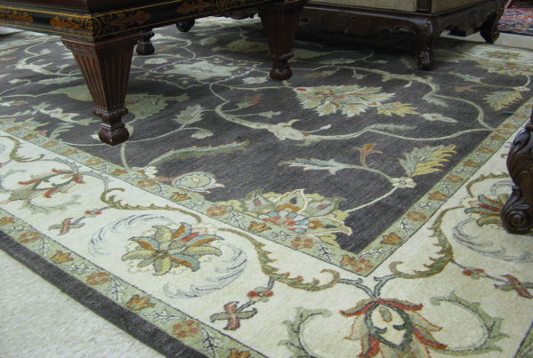 Appraisal: HAND KNOTTED ORIENTAL CARPET Persian floral design on rectangular charcoal