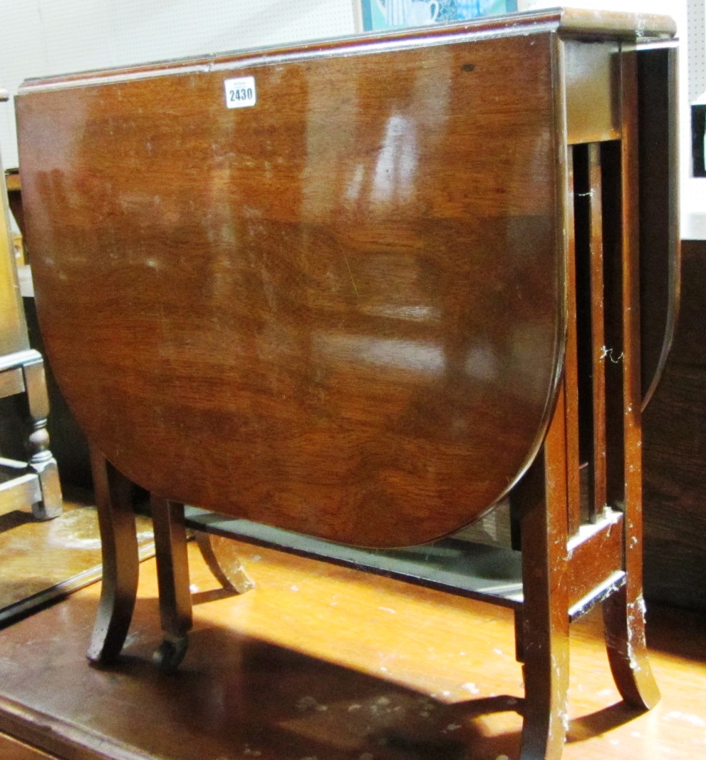 Appraisal: A mahogany drop flap and an oak two drawer cabinet