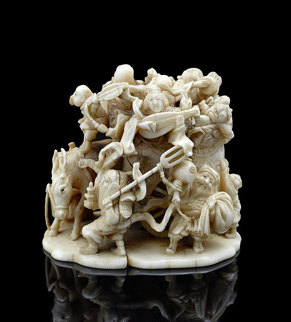 Appraisal: A Japanese ivory okimonoMeiji period - carved as a Shichifukujin