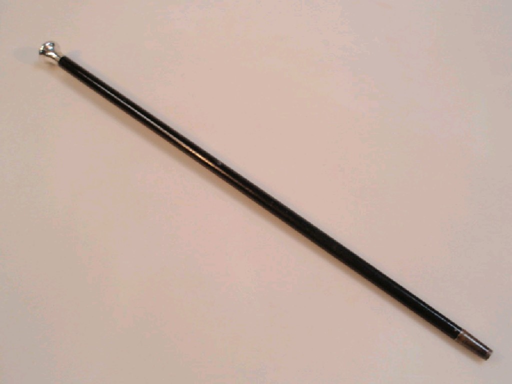 Appraisal: An ebonised swagger stick or baton with silver mounted knop