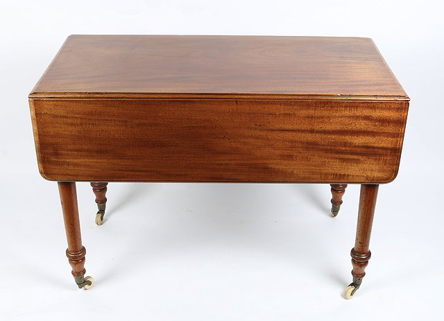 Appraisal: A VICTORIAN MAHOGANY PEMBROKE TABLE with turned tapering legs terminating