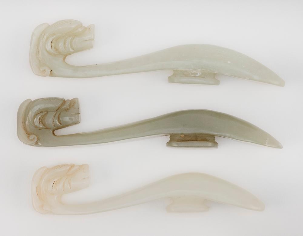 Appraisal: THREE CHINESE CELADON JADE GIRDLE HOOKS LENGTHS FROM TO THREE