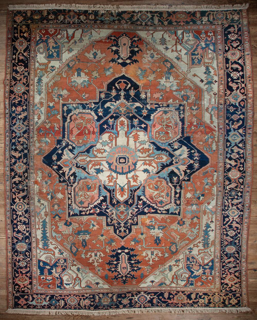 Appraisal: Serapi Rug red and cream ground central medallion blue border