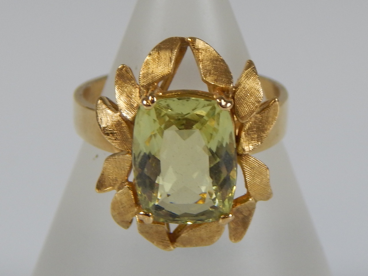 Appraisal: A peridot set dress ring with pierced openwork shank yellow