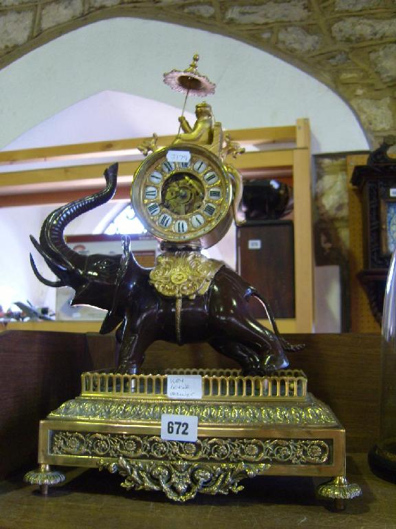 Appraisal: A reproduction brass and simulated bronze mantle clock in the