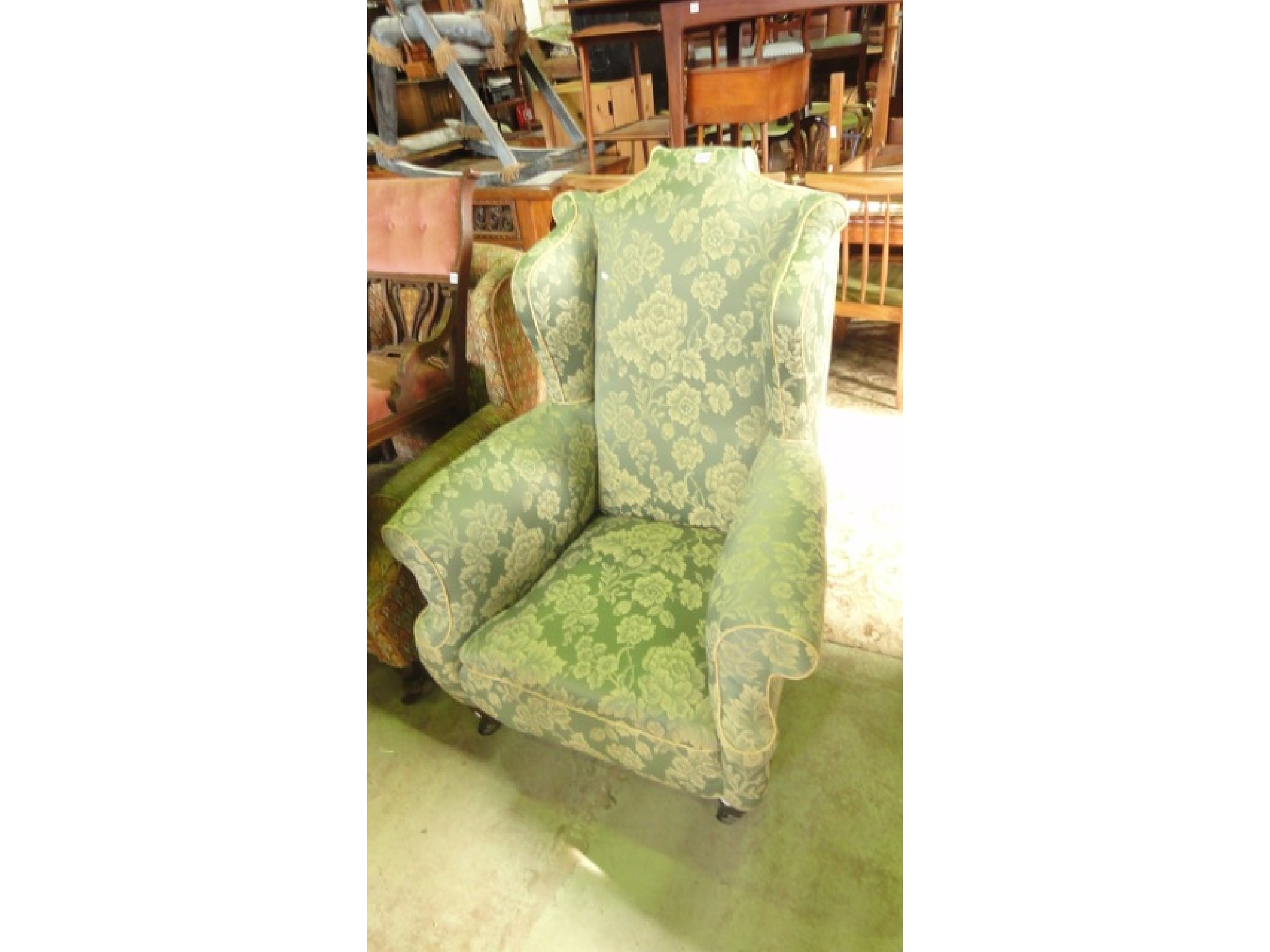 Appraisal: An Edwardian wing armchair in the Georgian style with shaped