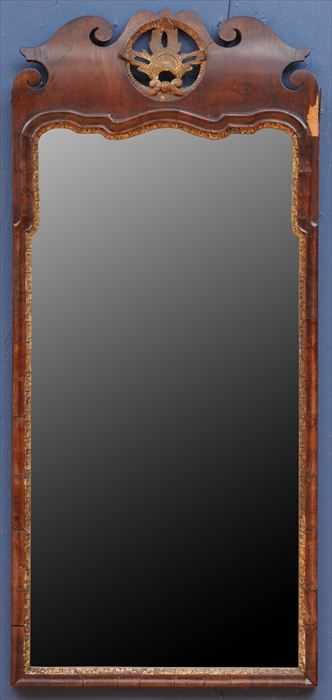 Appraisal: GEORGE II MAHOGANY AND PARCEL-GILT MIRROR The shaped cresting with