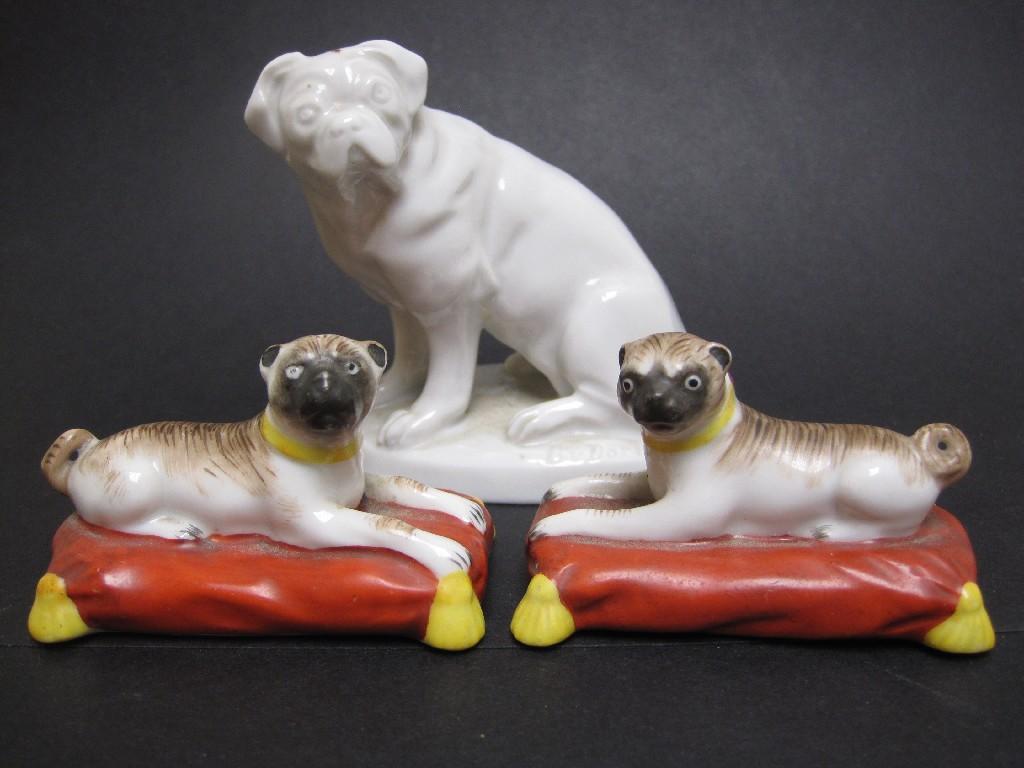 Appraisal: Pair of small seated Pug Dogs on iron red and