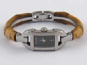 Appraisal: A lady's Gucci stainless steel L wristwatch with worn leather