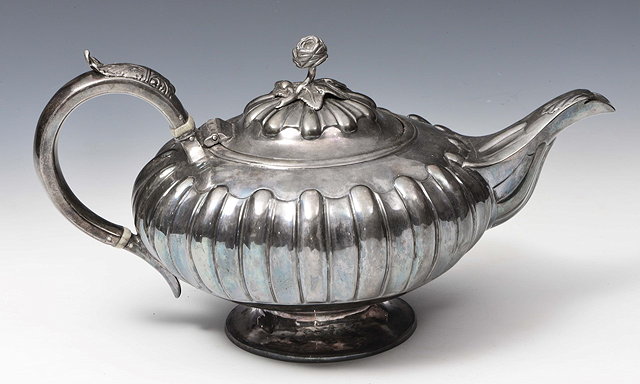 Appraisal: A GEORGE IV SILVER TEAPOT gourd shaped body standing on