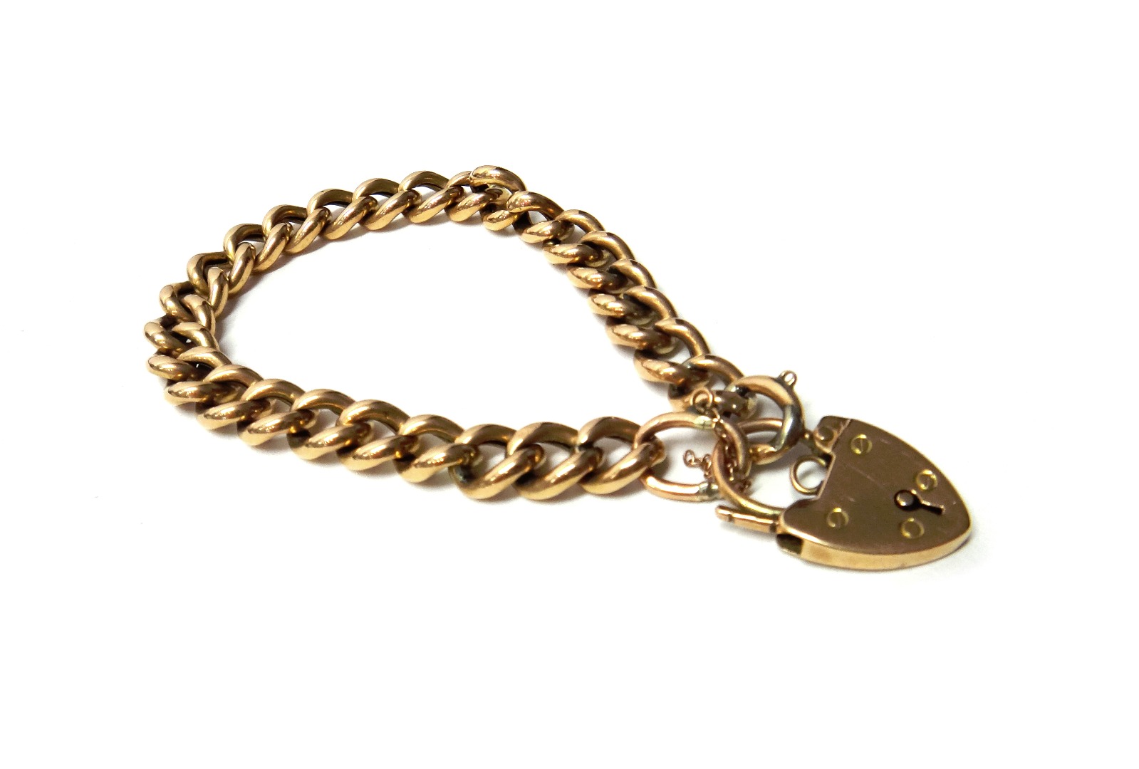 Appraisal: A gold curb link bracelet on a gold heart shaped